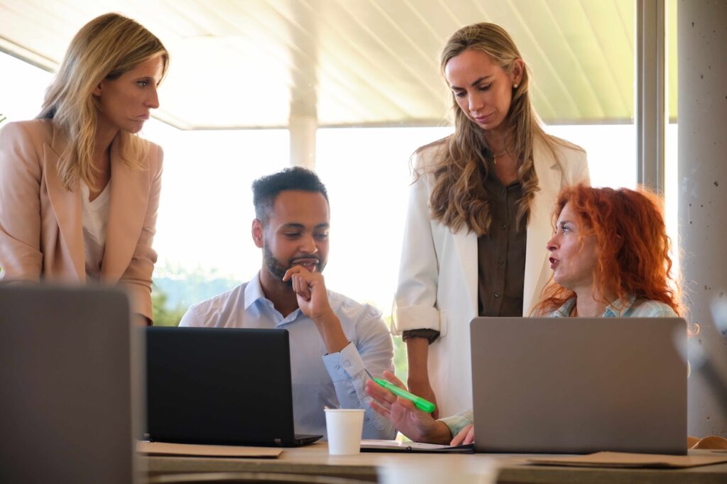 group of coworkers working on a project with help from it solutions consulting