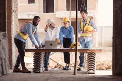 construction crew discussing plans using it support for construction companies